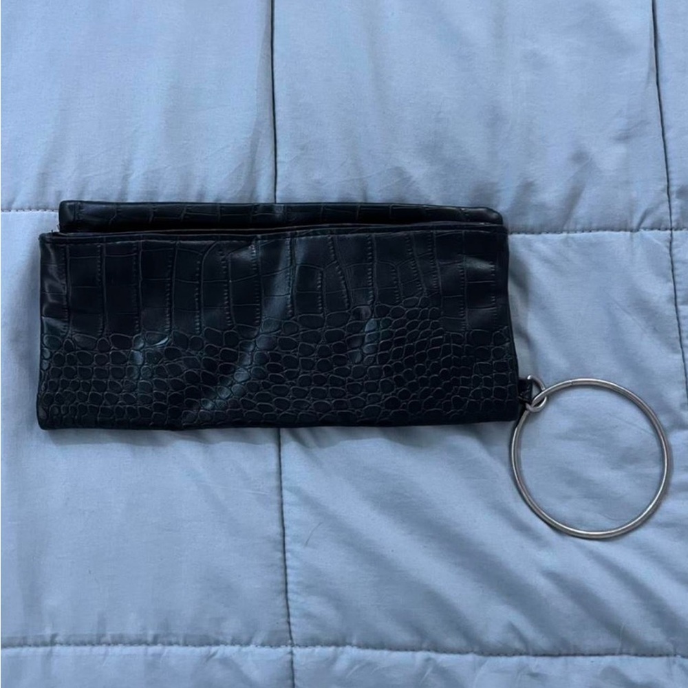 black clutch bag that folds out into a bigger handbag!